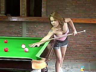 Busty Kate makes some shots on the pool table as she strips and poses